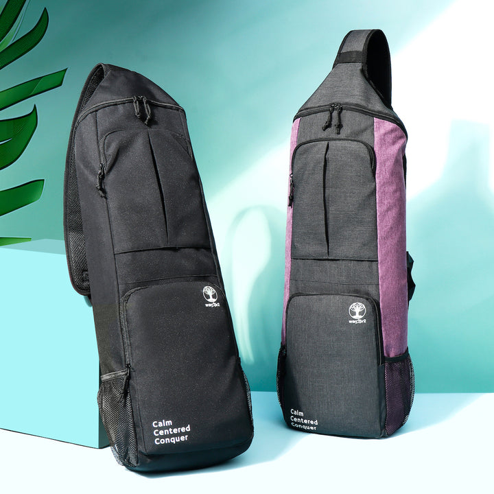 Front-facing view of Warrior2 yoga backpacks in black and purple-grey, upright on display with curved tops and zippered front pockets