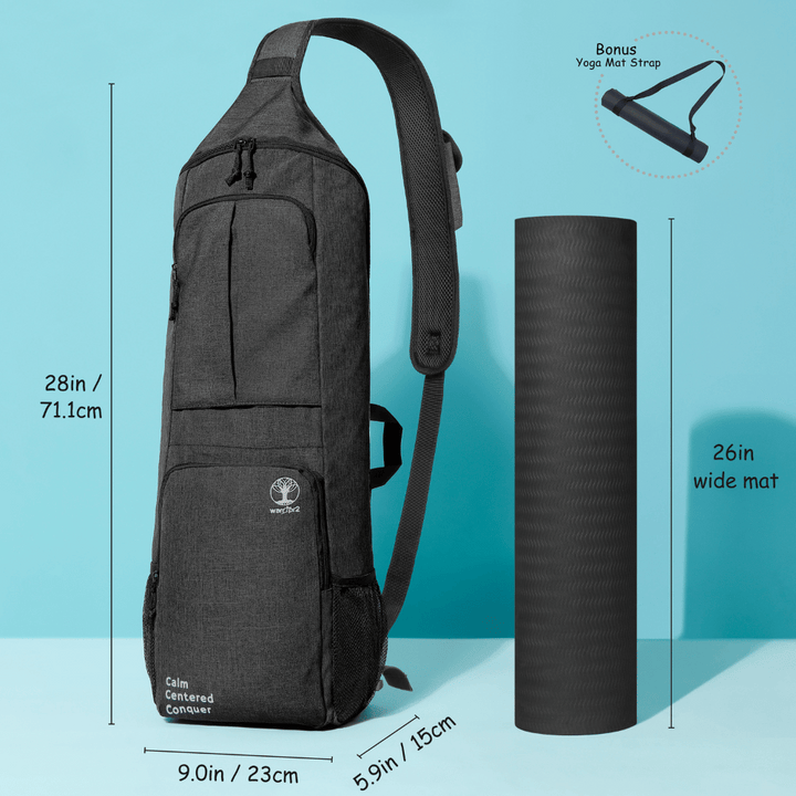 Black Warrior2 yoga bag standing next to a 26-inch wide yoga mat, showing full dimensions and bonus mat strap—fits Manduka PRO mat size