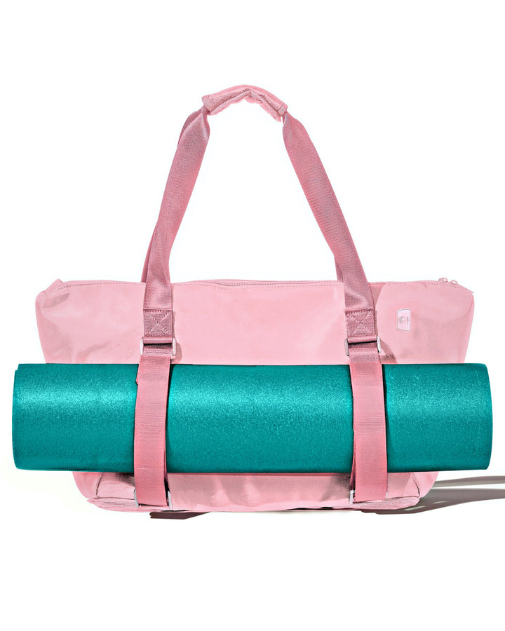 Warrior2 Pink yoga mat bag with a teal yoga mat on a white background