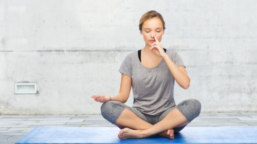 woman doing yoga breathing exercises sleep apnea