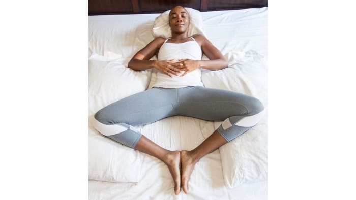 woman on bed Reclining Bound Angle Pose Yoga