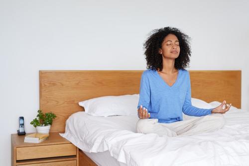 Woman on bed meditate yoga