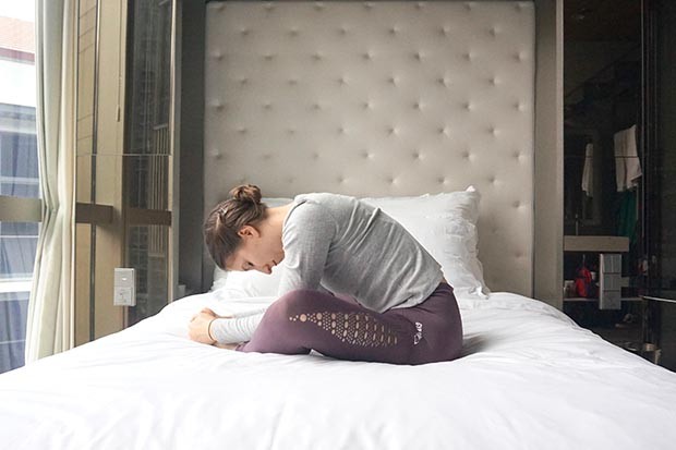 Woman on bed daytime yoga sleeping butterfly