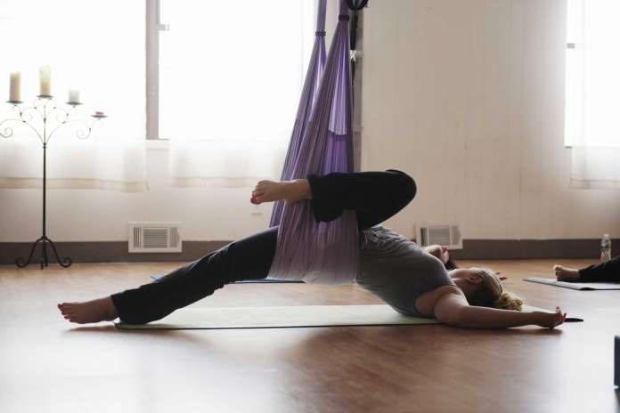 aerial yoga arched back and twist pose