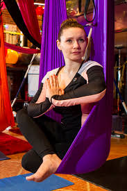 woman aerial yoga sitting in the hammock