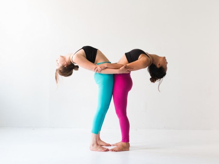 supported backbend two girls doing yoga