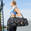 woman active blue top carrying warrior2 gym duffle bag black white blue sky