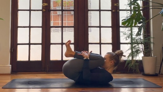 woman do yoga ball pose boost productivity