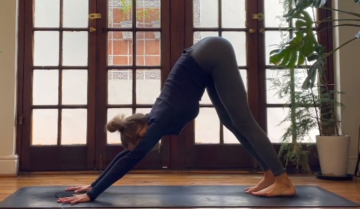 yoga woman do downward dog pose yoga daytime indoor practice guide