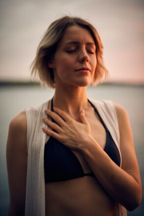 woman hand on chest breathing calm yoga hatha