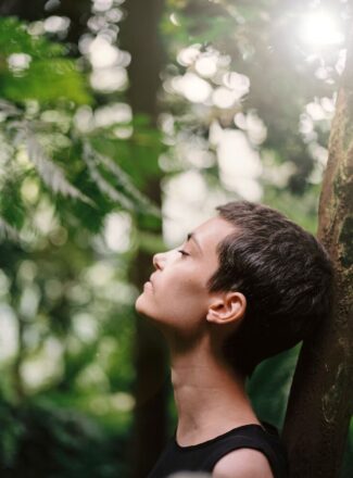 woman breathing forest green daytime hatha yoga