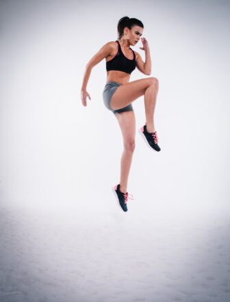 woman jumping yoga white background