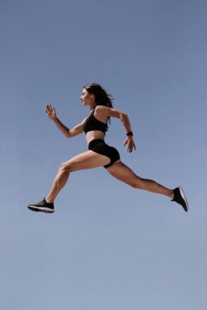 girl sports clothes running mid air yoga
