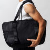 masculus man arm holding black gym bag white shirt